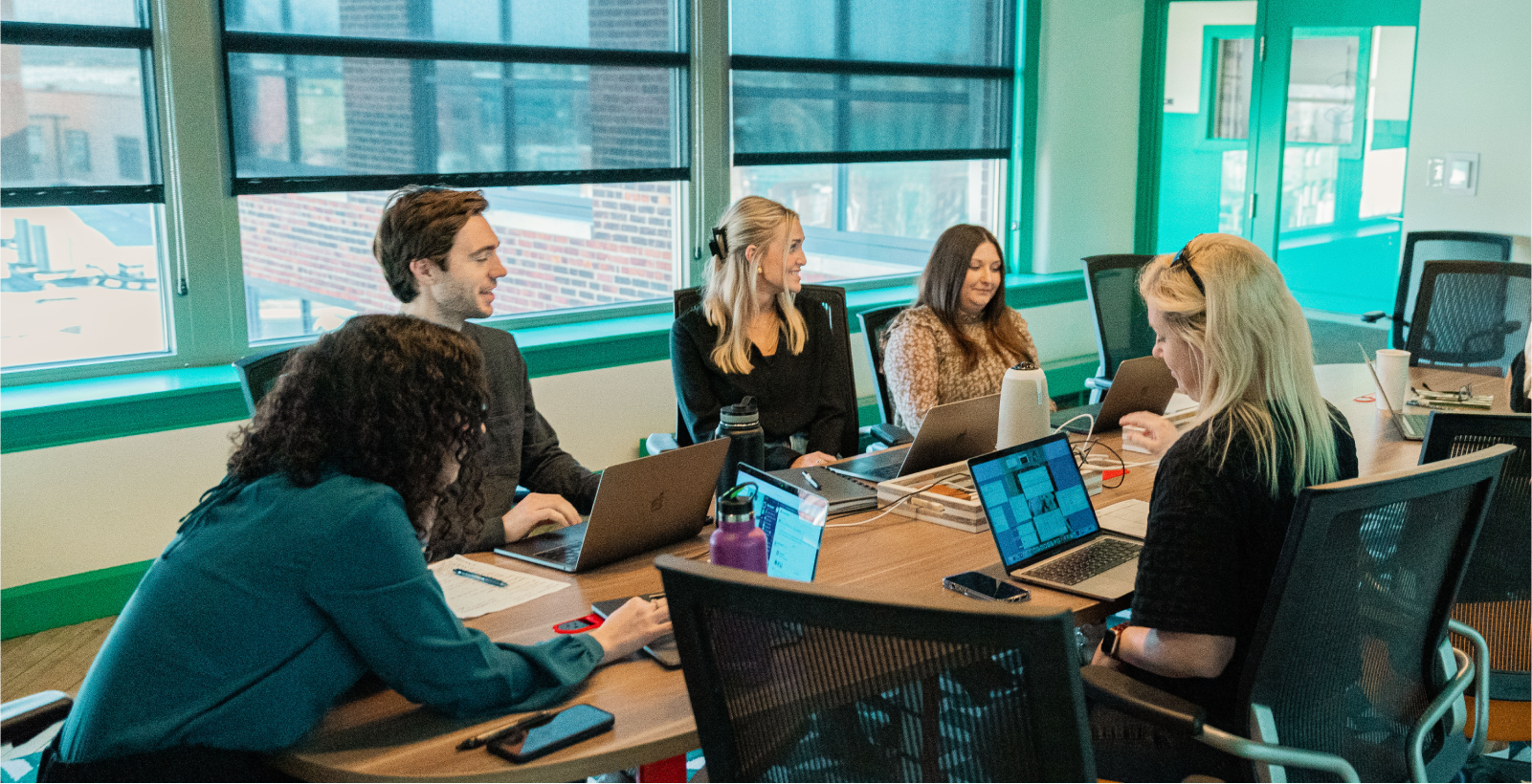 Three team members viewing a video